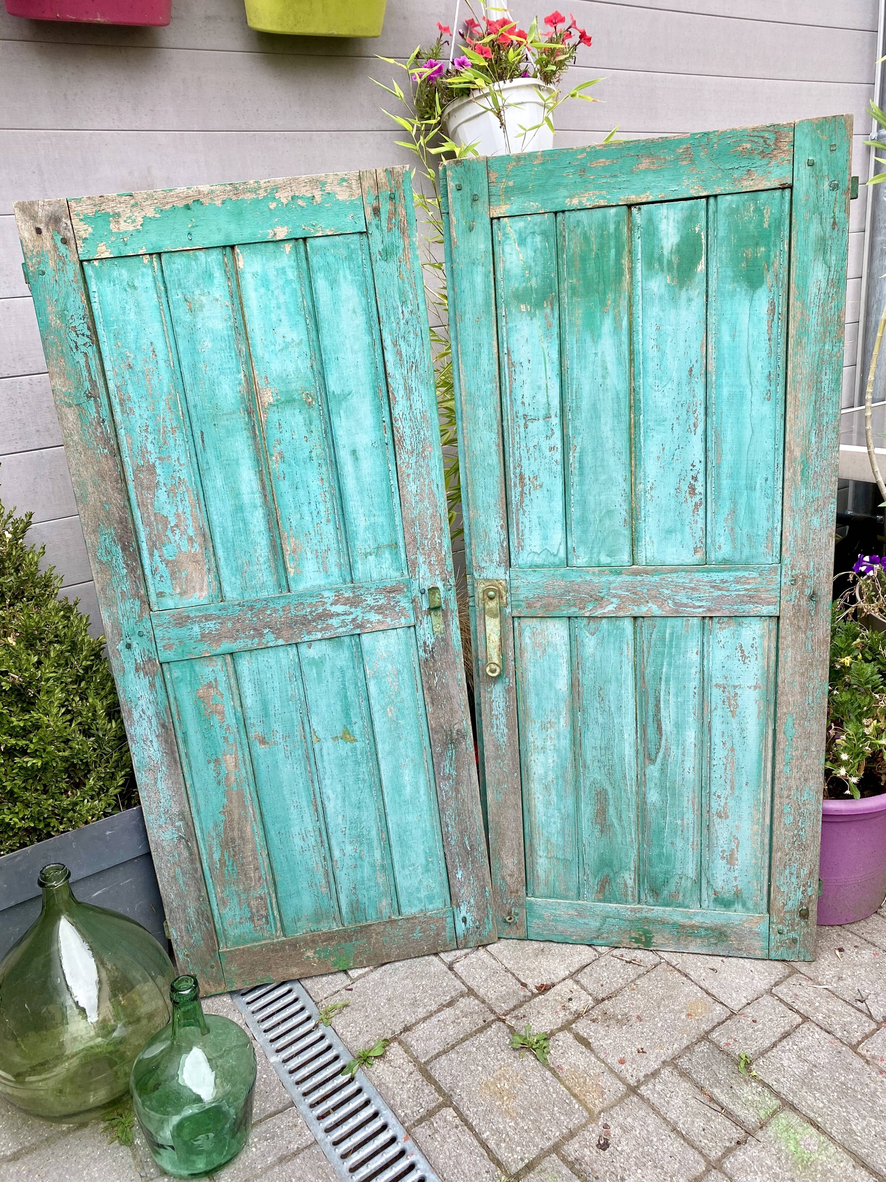 Pair of old wooden shutters green mint color