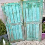 Pair of old wooden shutters green mint color