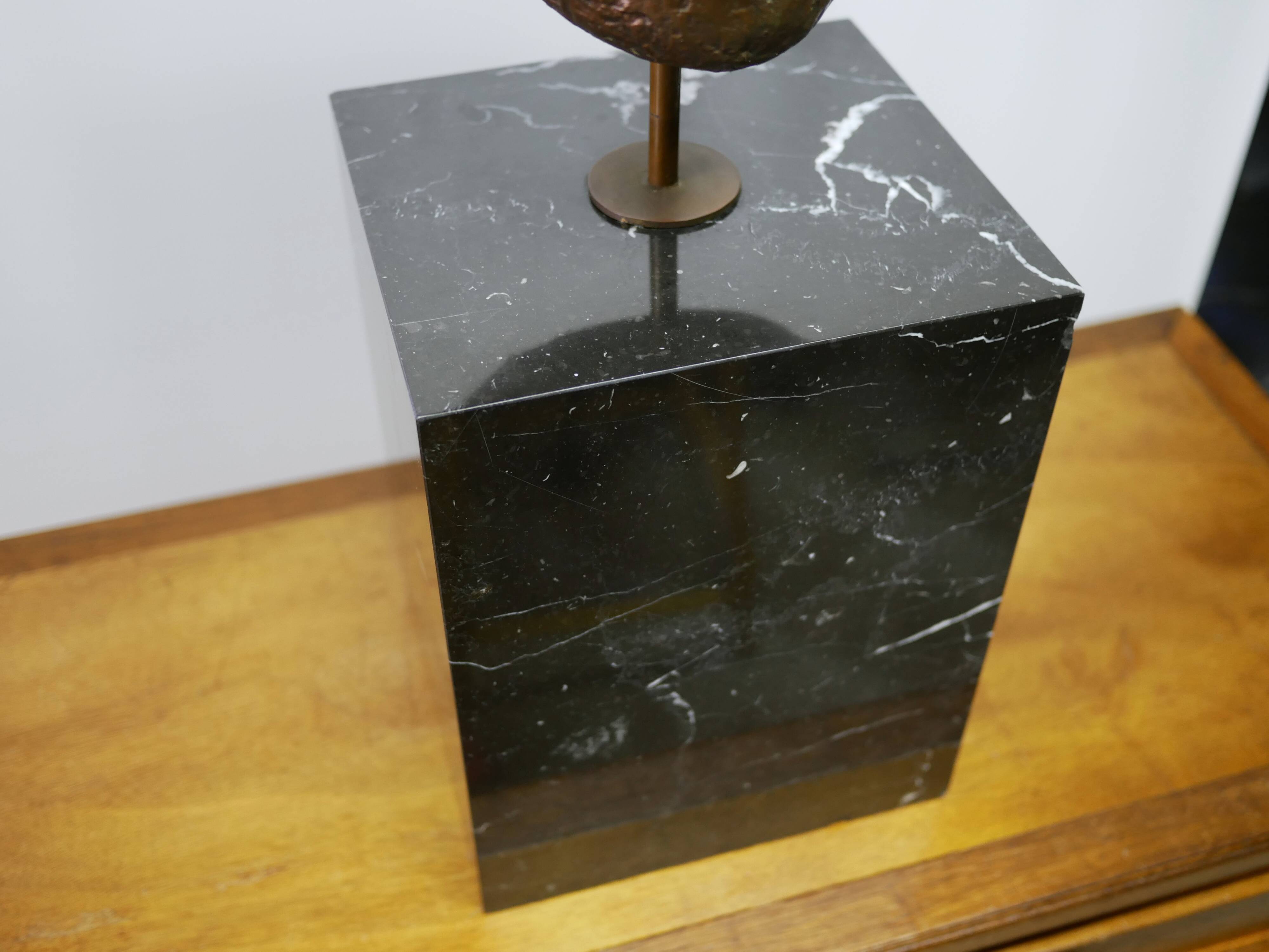 Buddha head sculpture, marble base