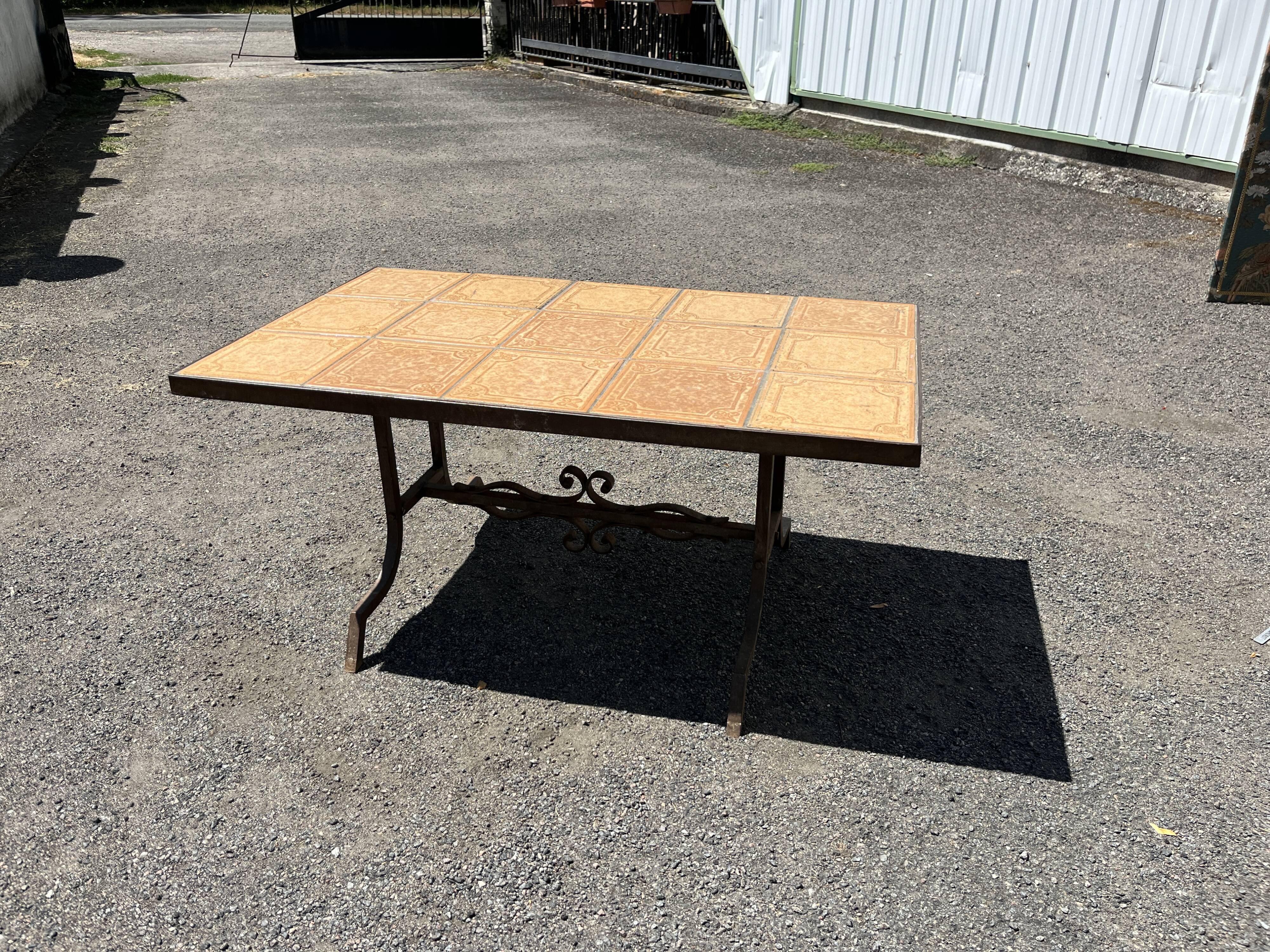 Vintage garden table with ceramic tile top and wrought iron base