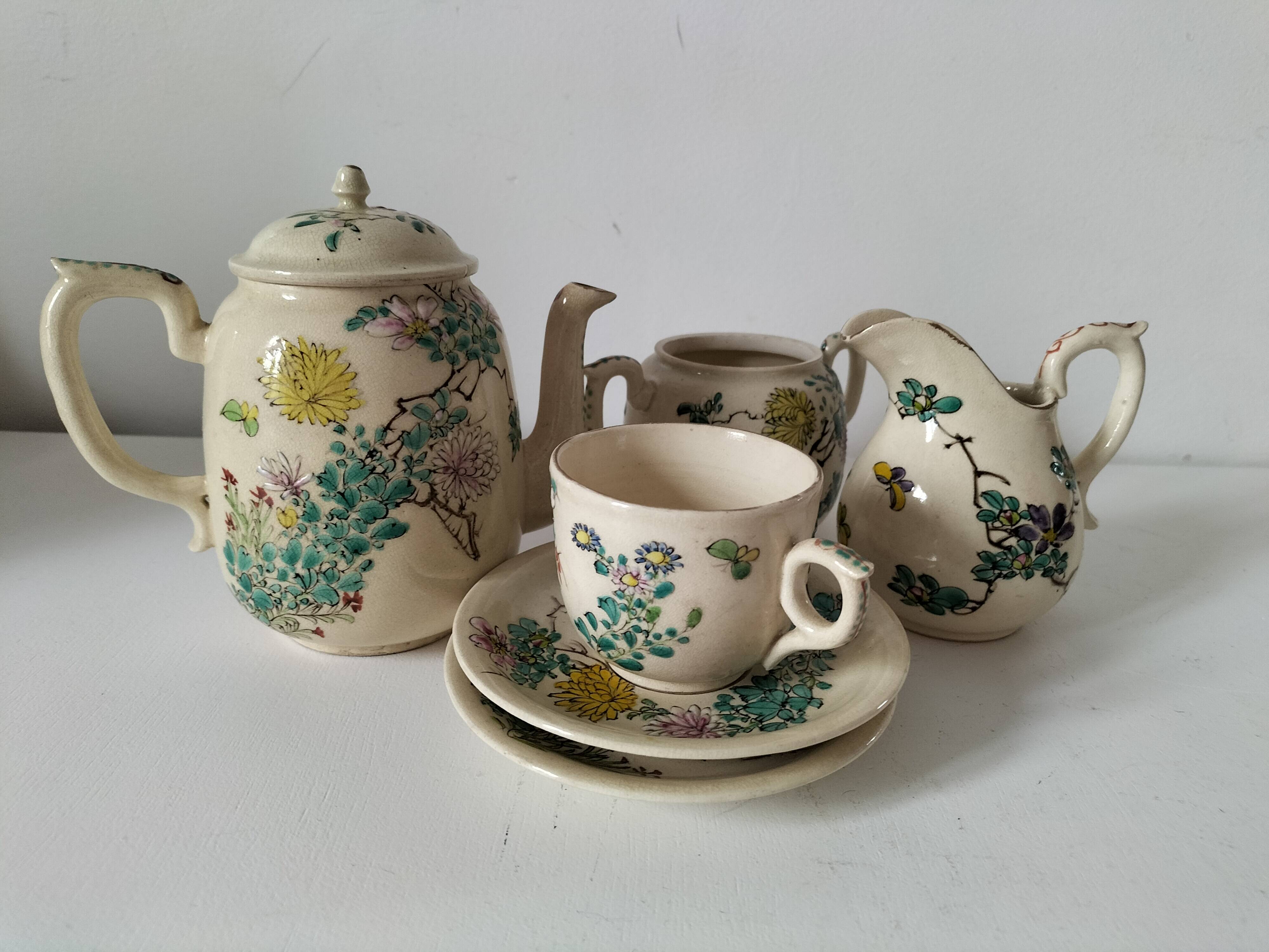 Japanese-style tea set in cracked earthenware with chrysanthemum flowers