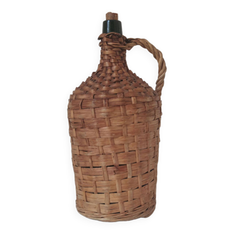 Old demijohn in wicker-vintage wicker bottle 1950s-1960s