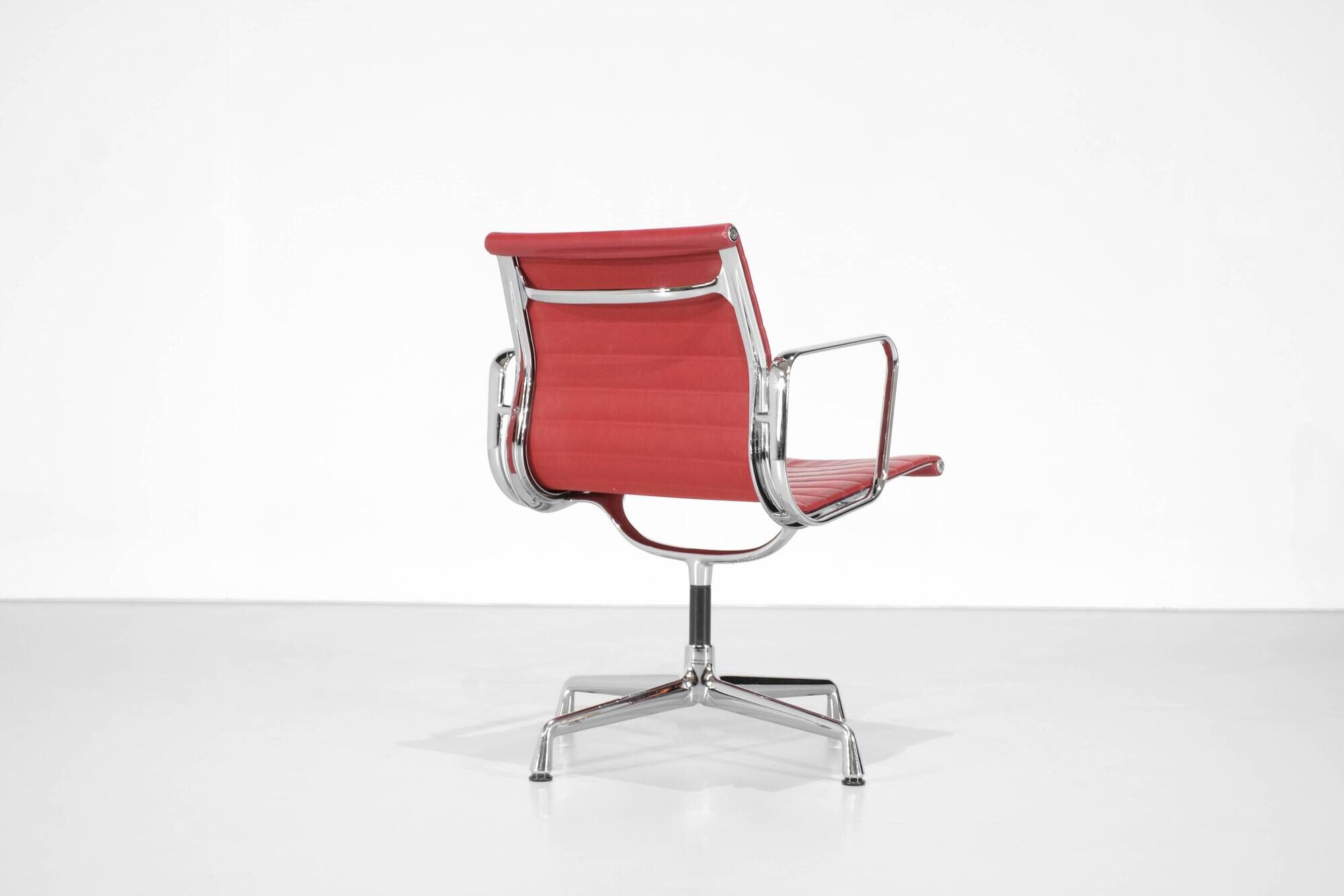 "EA 108" armchair in red leather, designed by Charles and Ray Eames for Vitra,