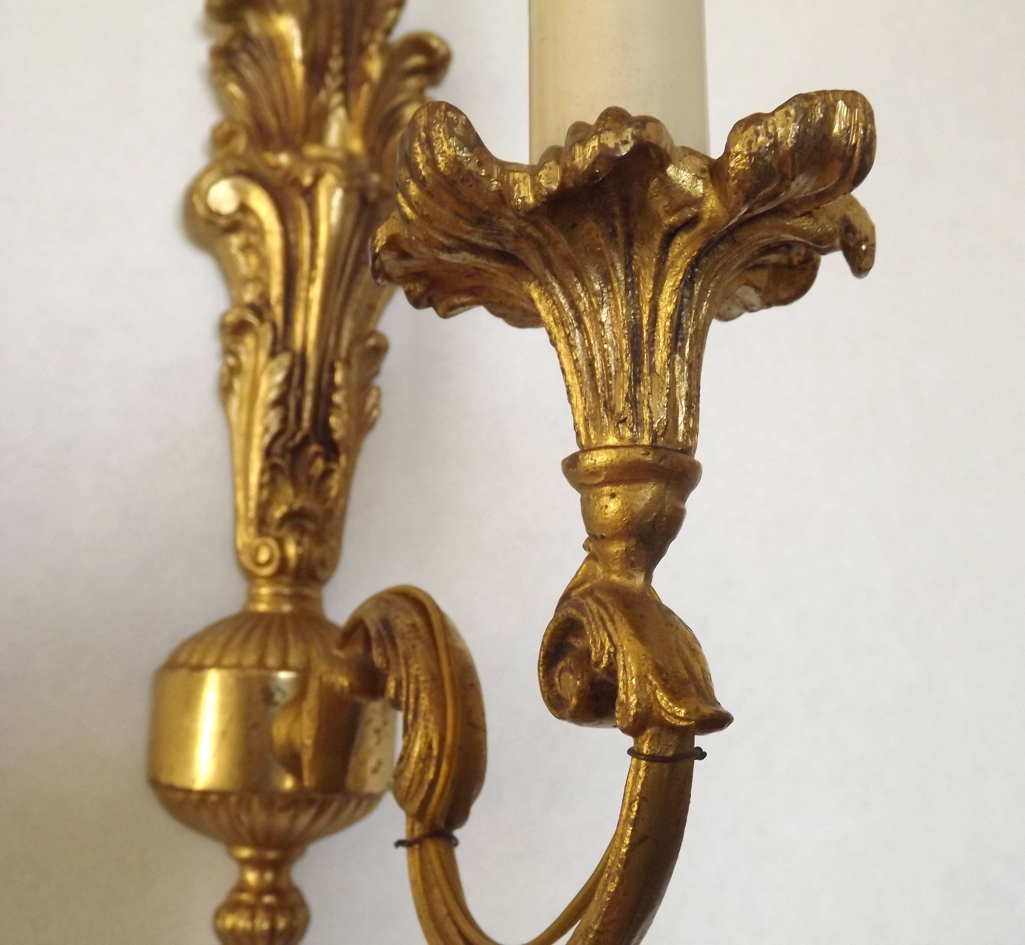 Pair of simple vintage French wall sconces in Art Nouveau bronze with leaf-shaped details.