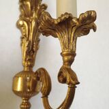 Pair of simple vintage French wall sconces in Art Nouveau bronze with leaf-shaped details.
