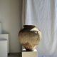 Very large grey and red terracotta pot with handles and rattan crossbars.