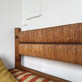 Brutalist style bed with chain and straw