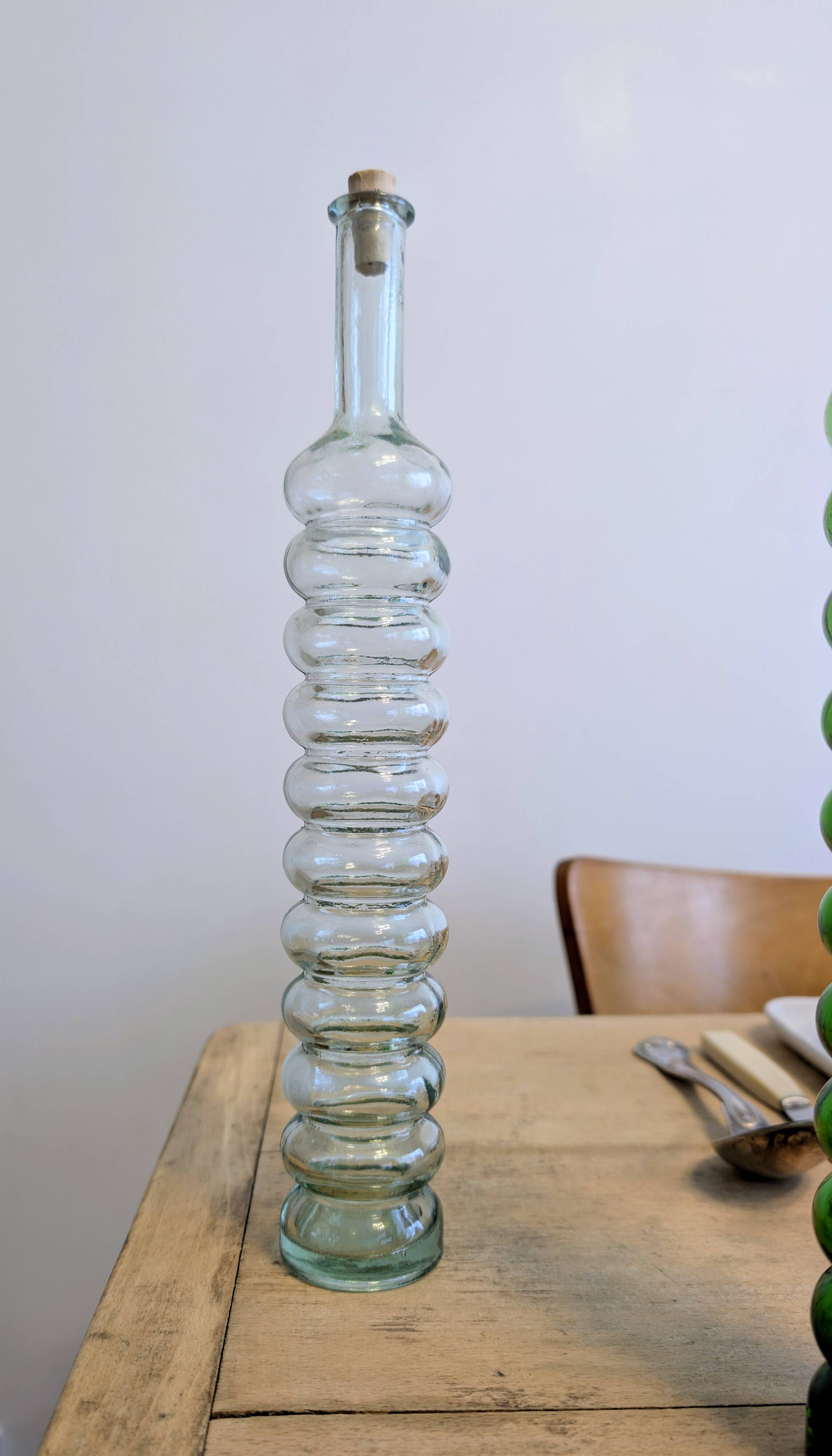 Pair of vintage ribbed blown glass bottles with cork stoppers.