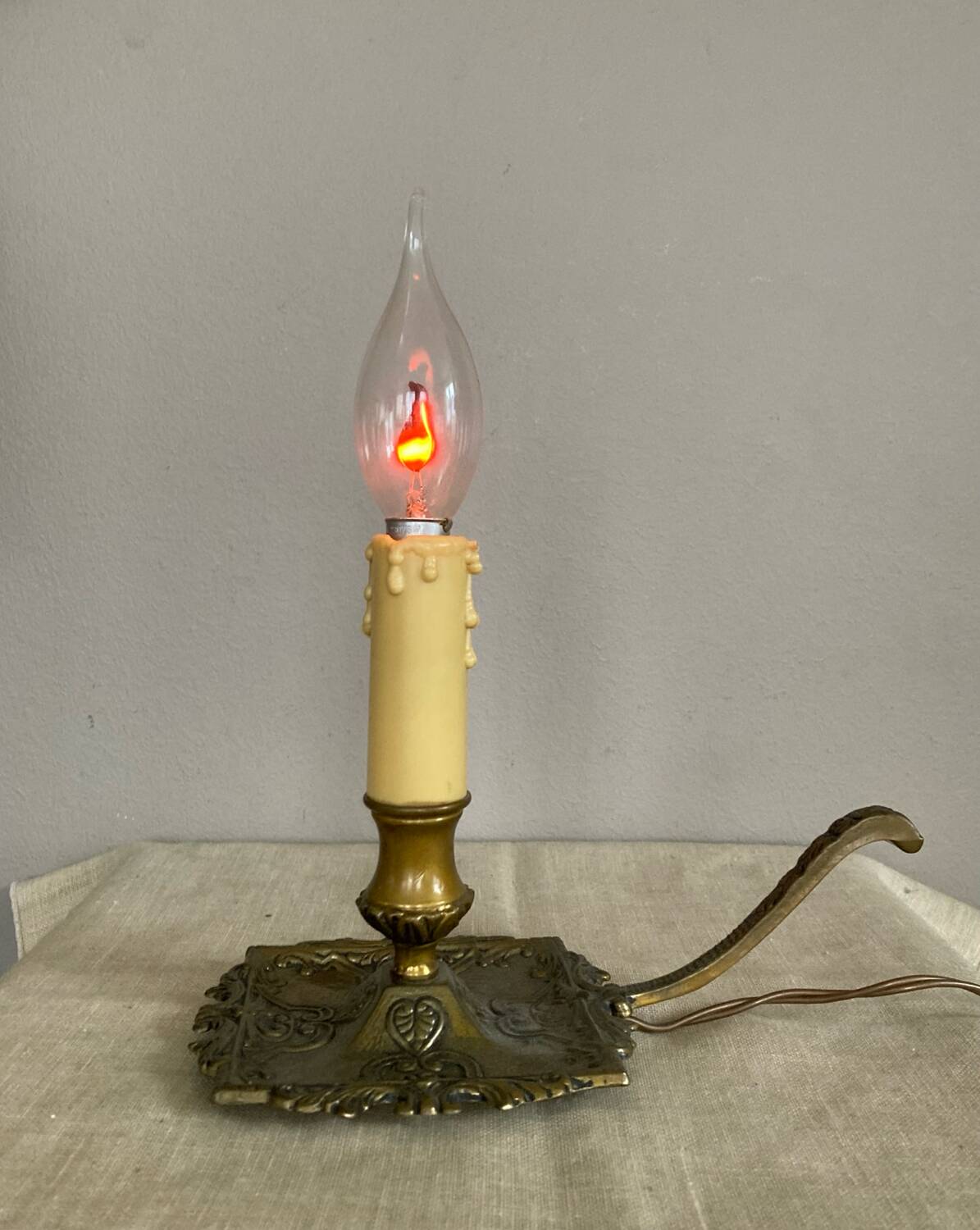 Candle holder with 20th century spelter socket mounted as a flame bulb lamp