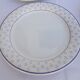 Set of 4 white and blue dinner plates.
