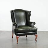 Smooth classic cowhide Chesterfield armchair in a stylish dark green color