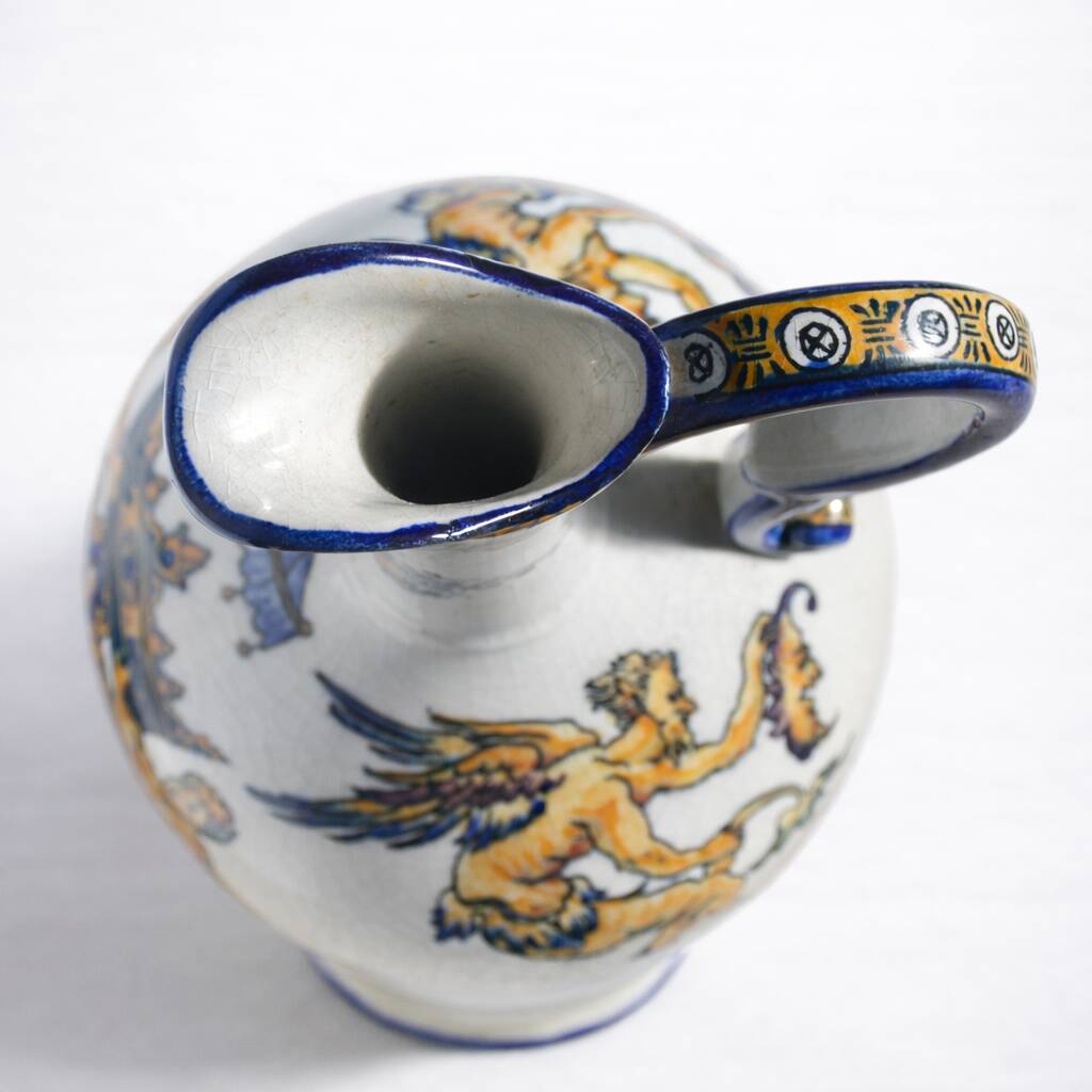Gien earthenware jug, Renaissance decoration, putto with dolphin.