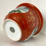 Chinese planter or Chinese porcelain pot cover decorated with landscapes on a coral and golden background