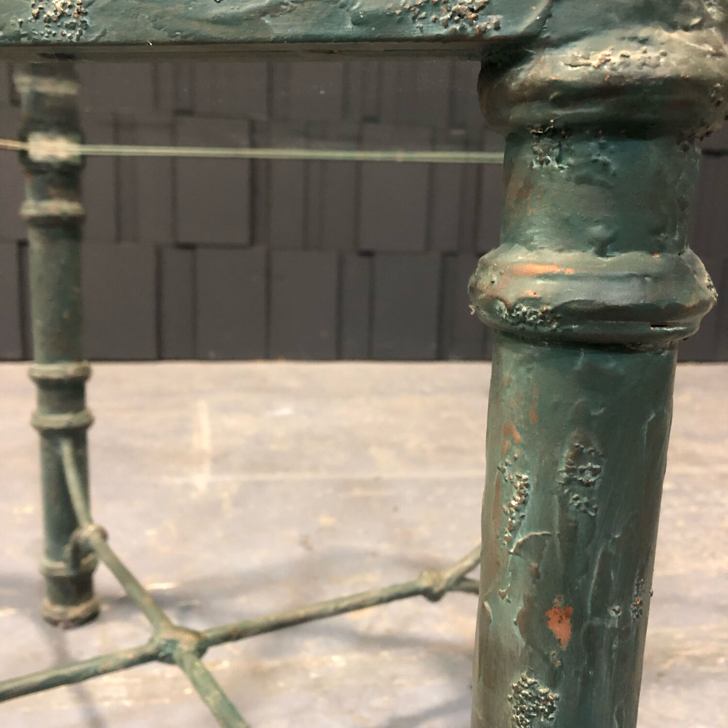 Iron and glass side table with antique patina