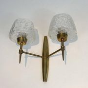 Pair of bronze wall sconces with worked glass reflectors. Stilnovo