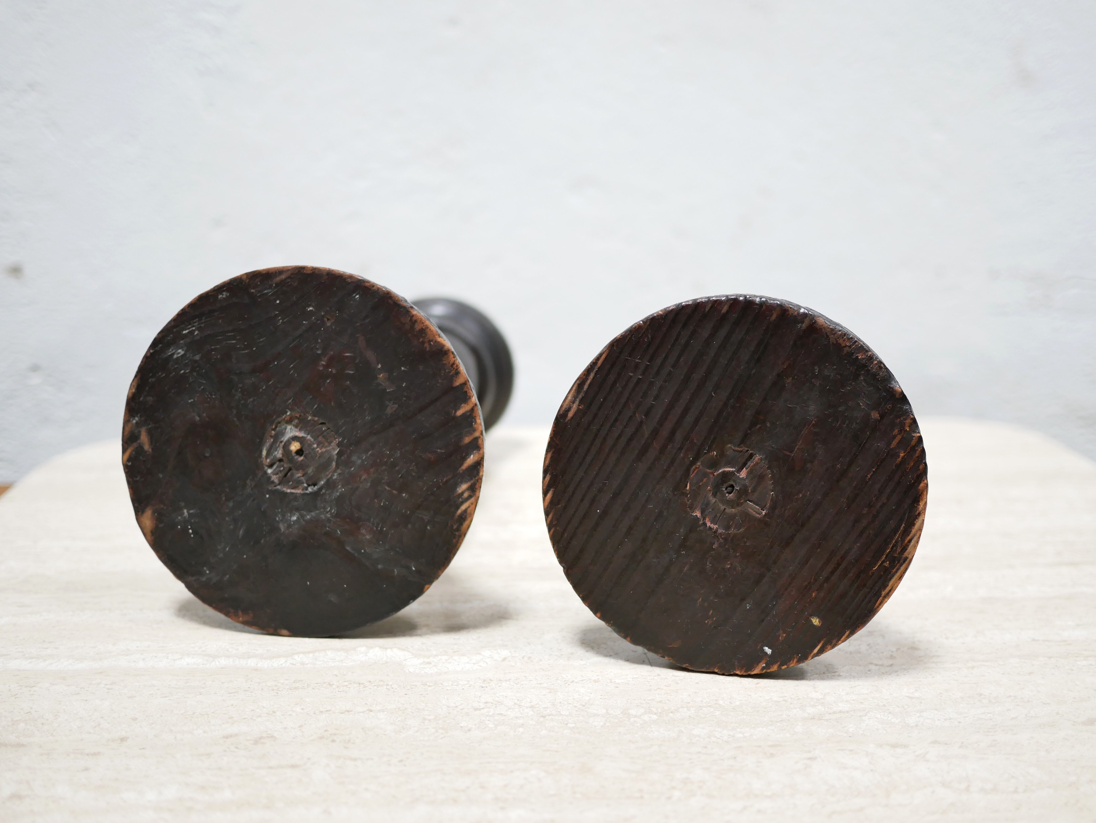 Pair of antique turned wooden candle holders