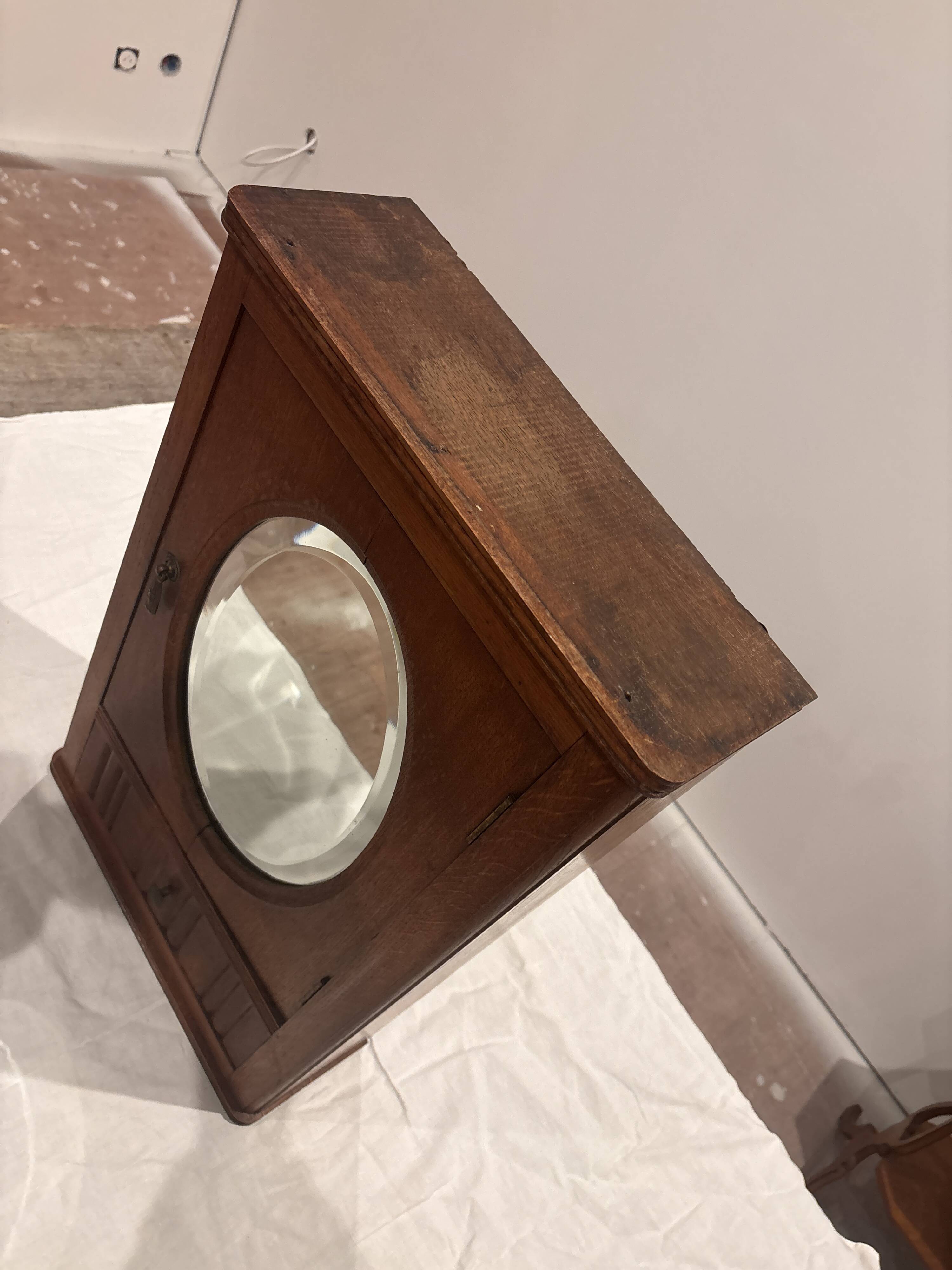 Wall cabinet with oval wall and drawer