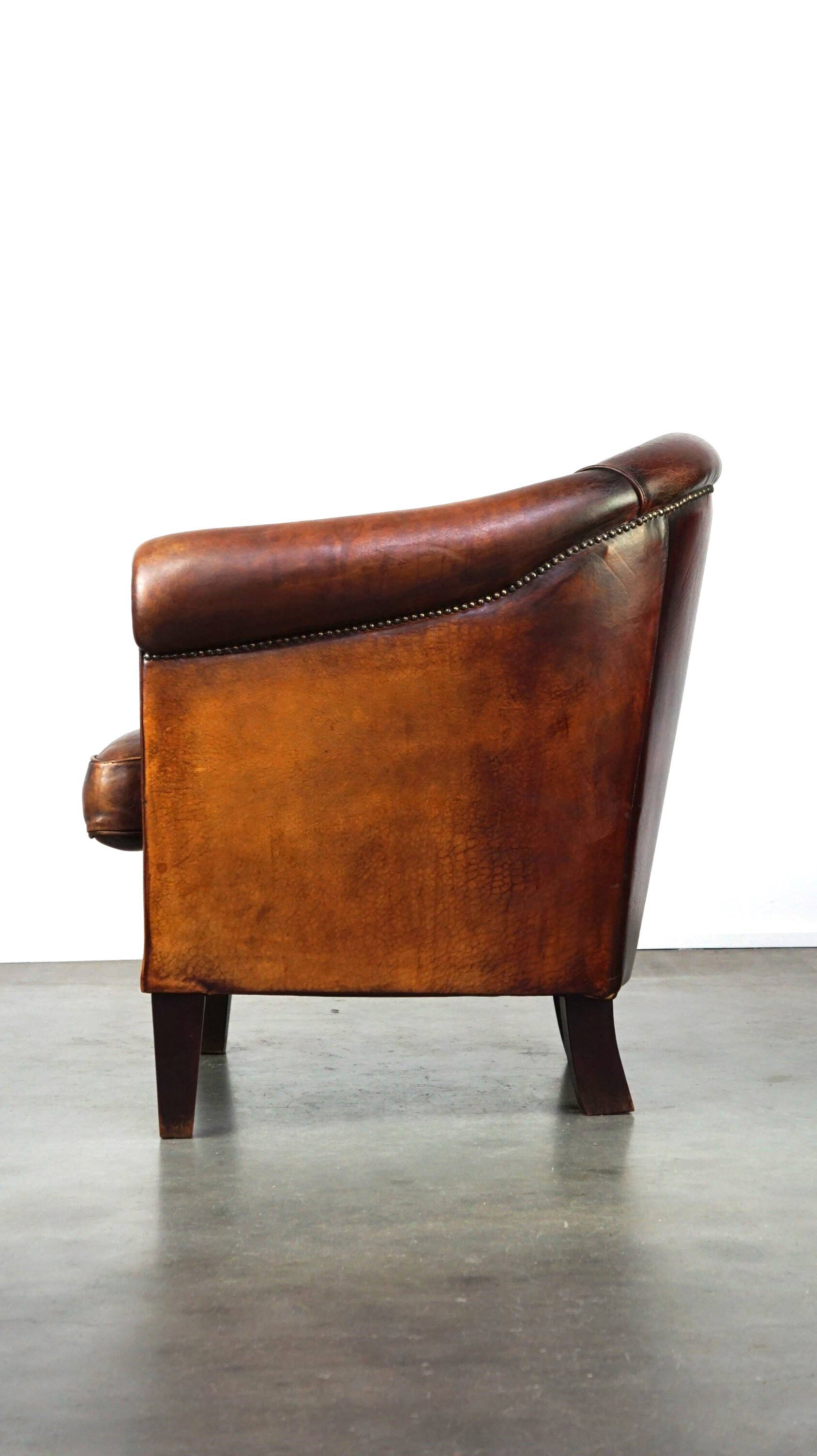 Very luxurious dark brown sheepskin club chair with a more than beautiful patina