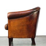 Very luxurious dark brown sheepskin club chair with a more than beautiful patina
