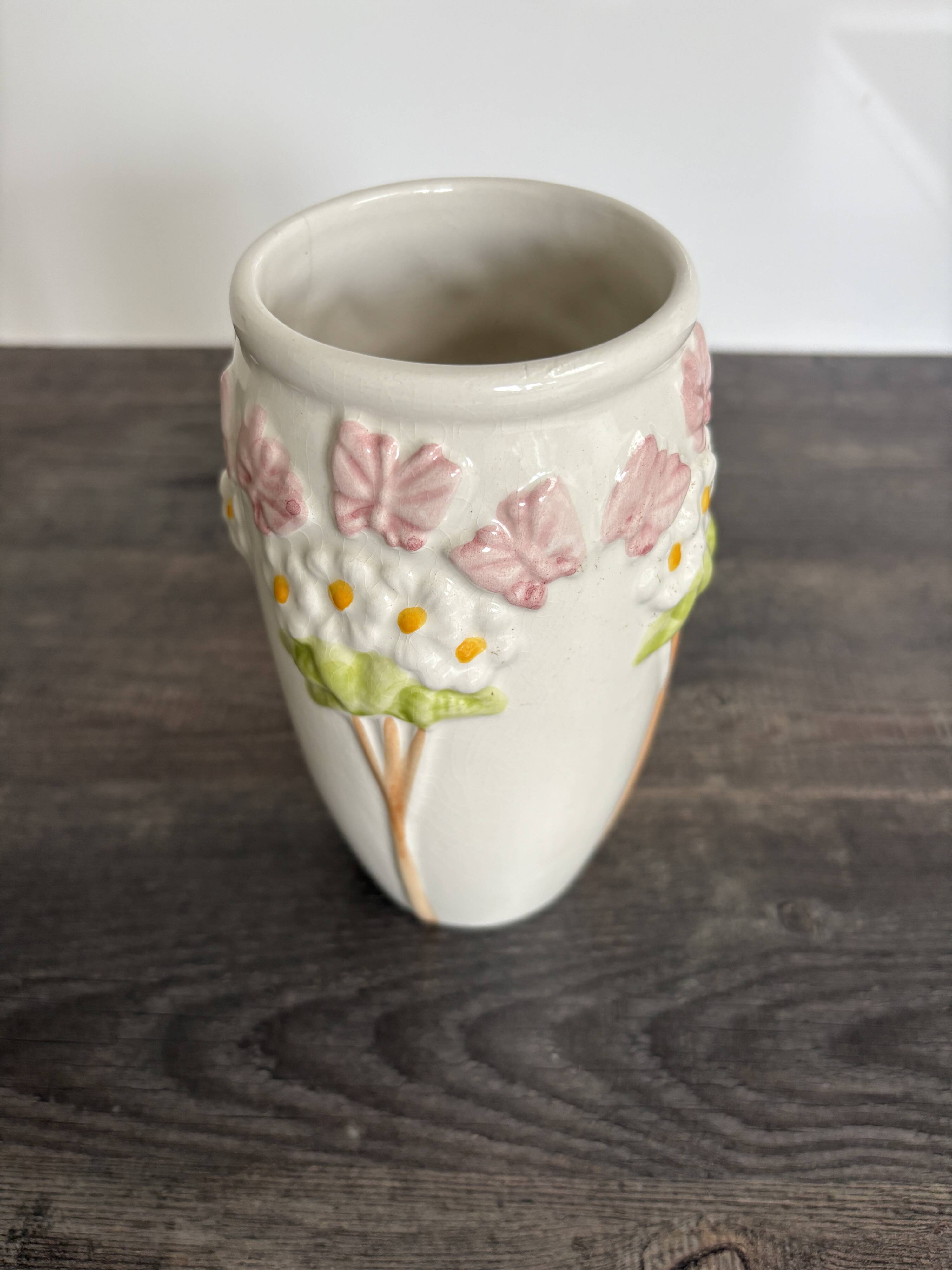 Antique ceramic vase with flowers and butterflies
