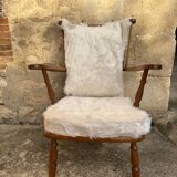 Scandinavian armchair in solid wood with beige fur cushion
