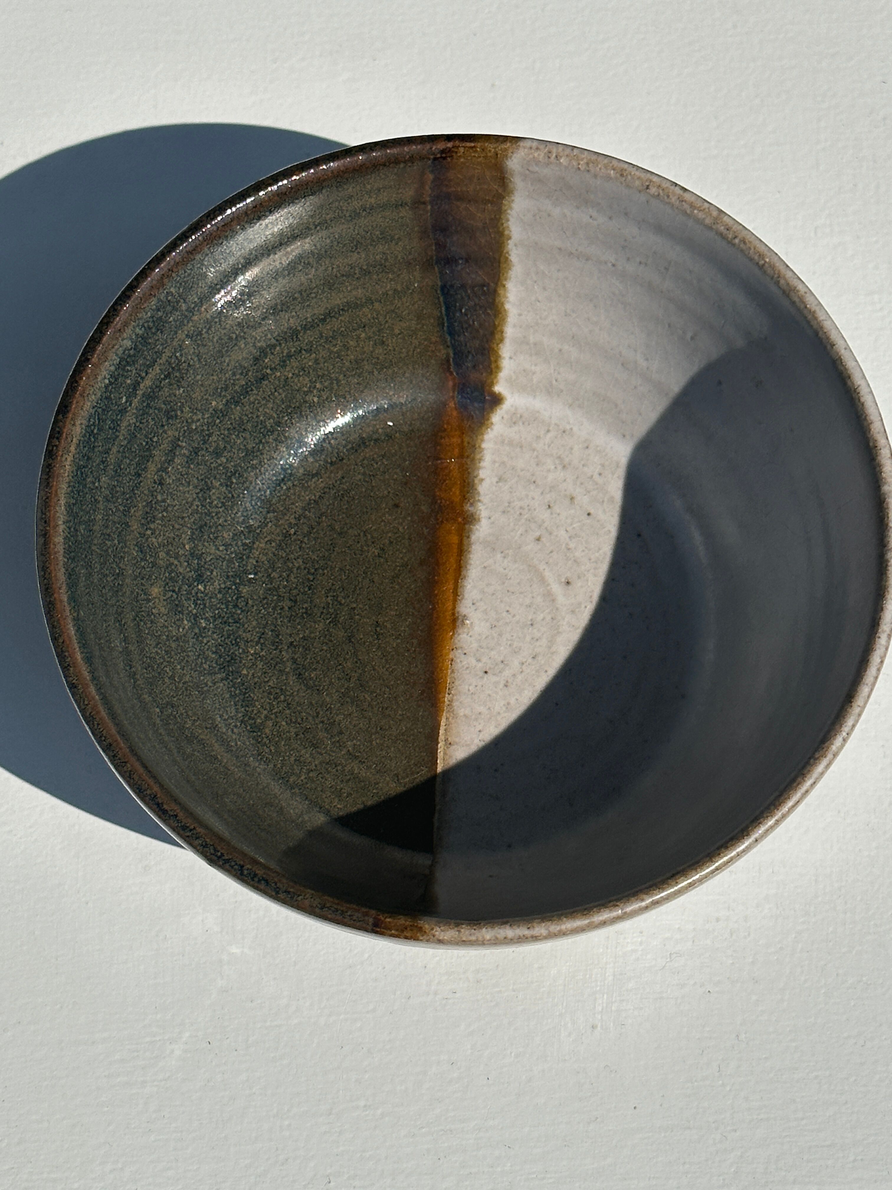 White and glossy brown two-tone ceramic bowl, matt earth