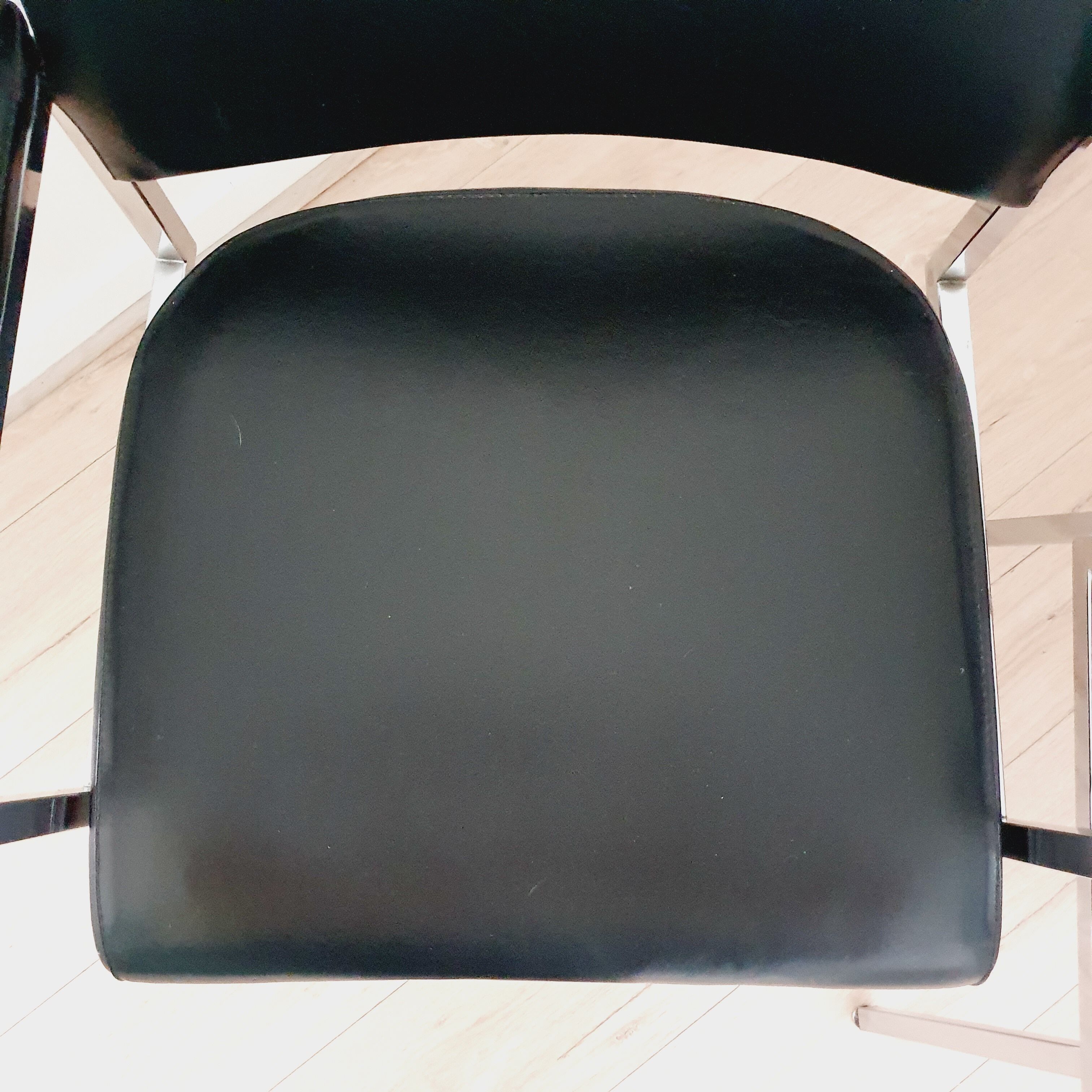 Pair of black skaï and chrome armchairs