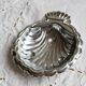 Vintage shell-shaped shiny silver-plated catchall.