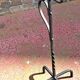 Old ashtray on twisted hammered wrought iron legs, vintage decor.