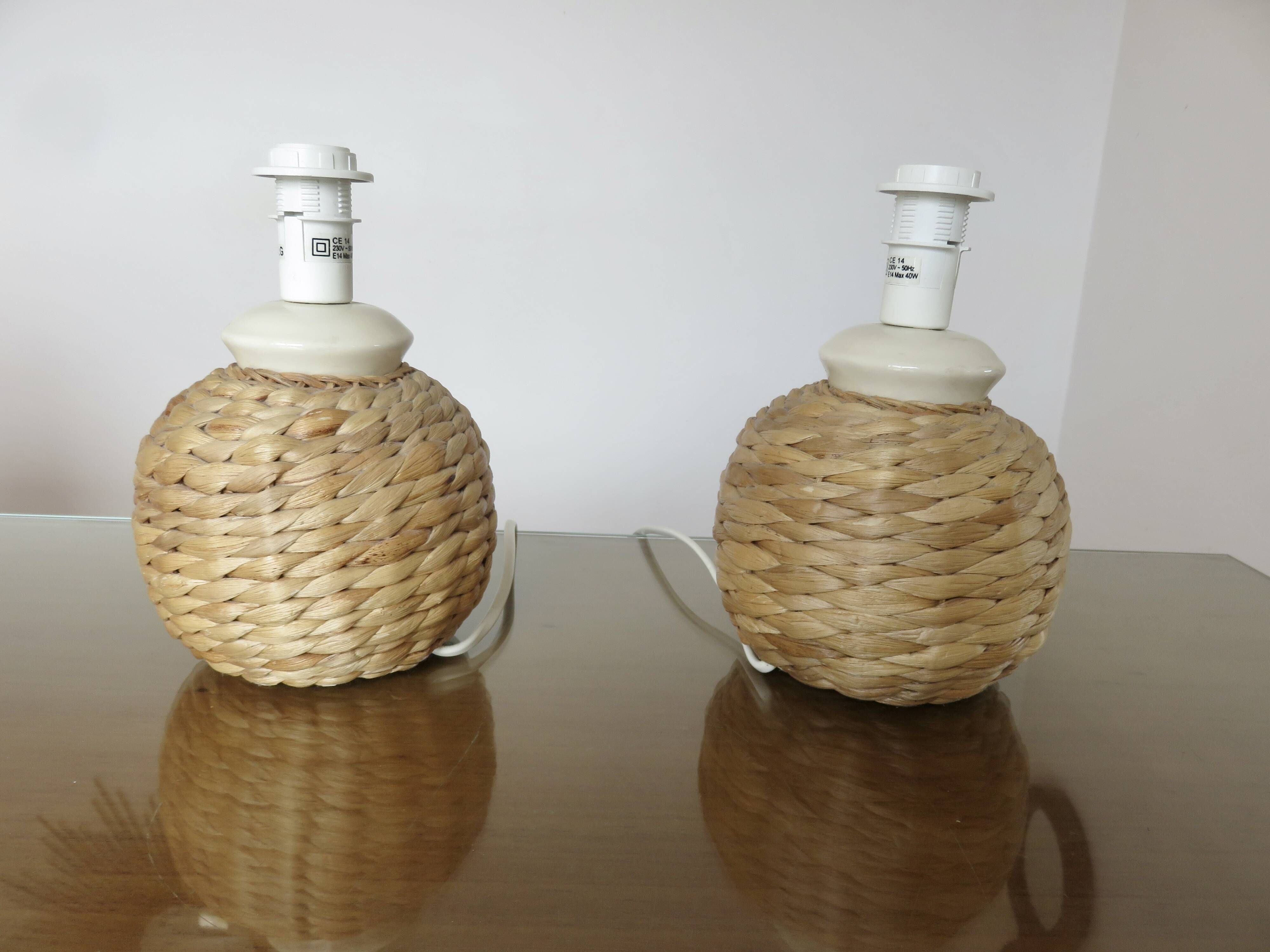 Pair of bedside lamps made of woven sea rush, matching lampshades, 1980.