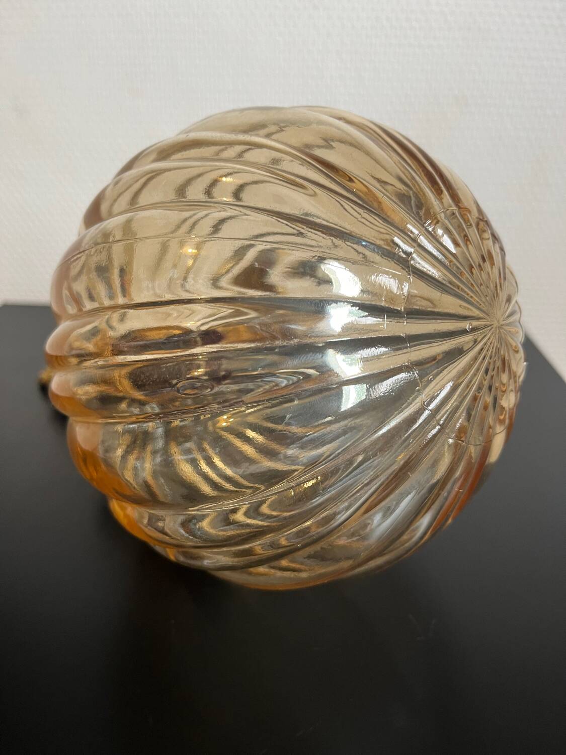 Brass wall light and bubbled glass globe