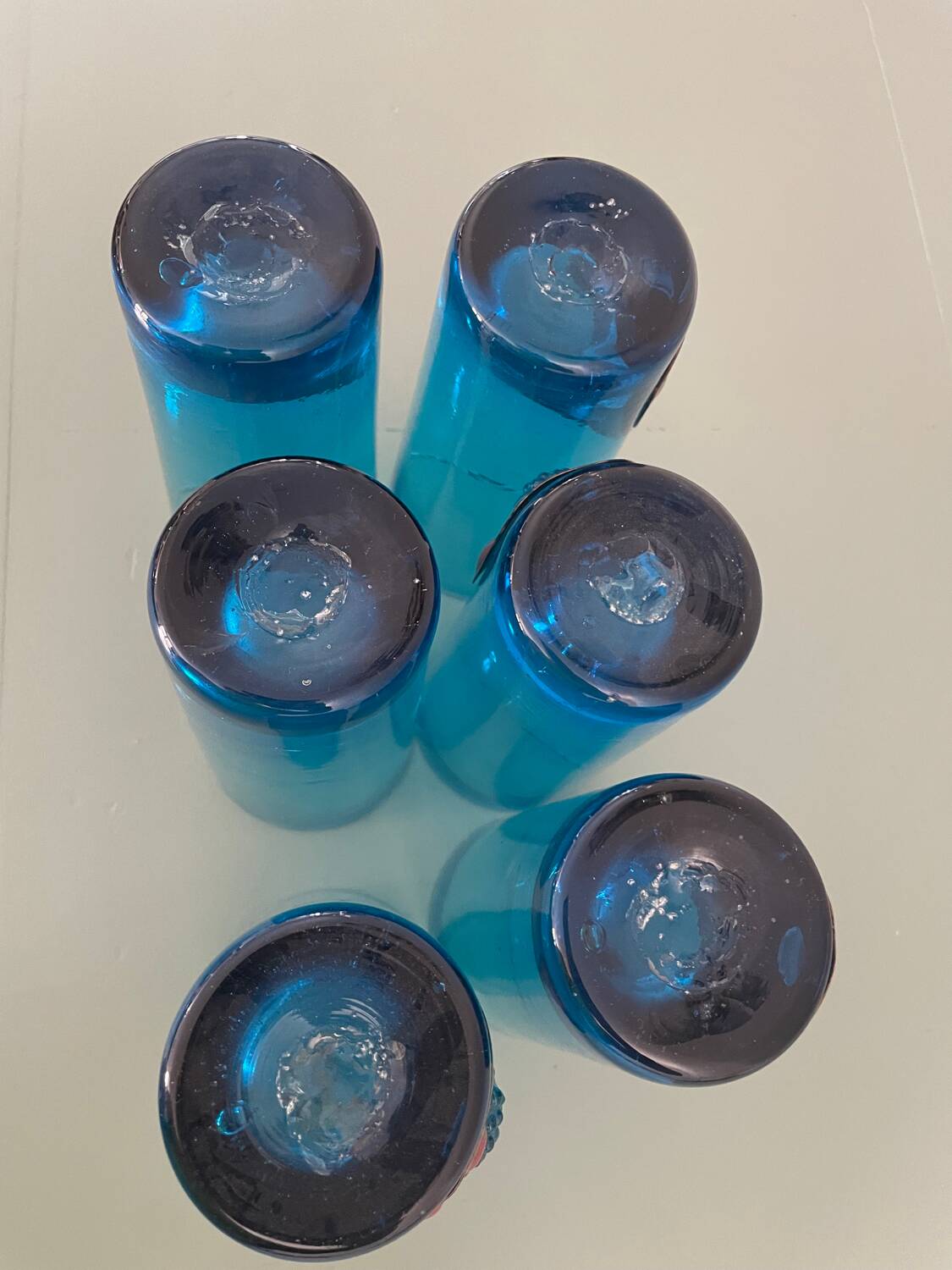 Six blue blown glass and enamel on copper glasses.