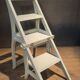 White chair convertible into a staircase.