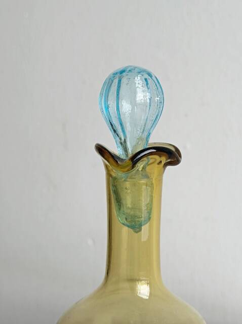 Old glass vial in yellow and blue.