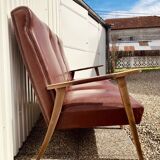 Three-seater patinated leather sofa, mid-century style.