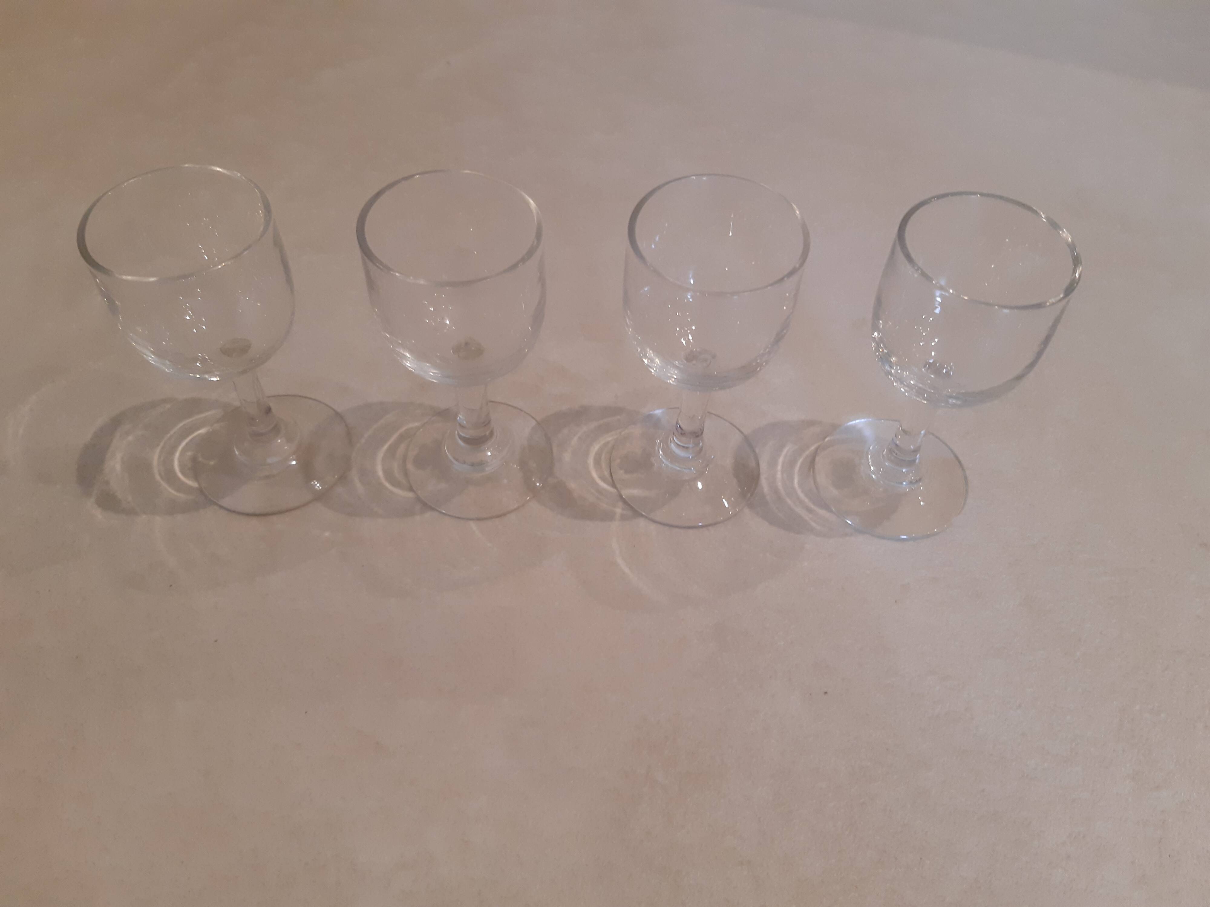 Set of 4 small stemmed glasses for strong alcohol.