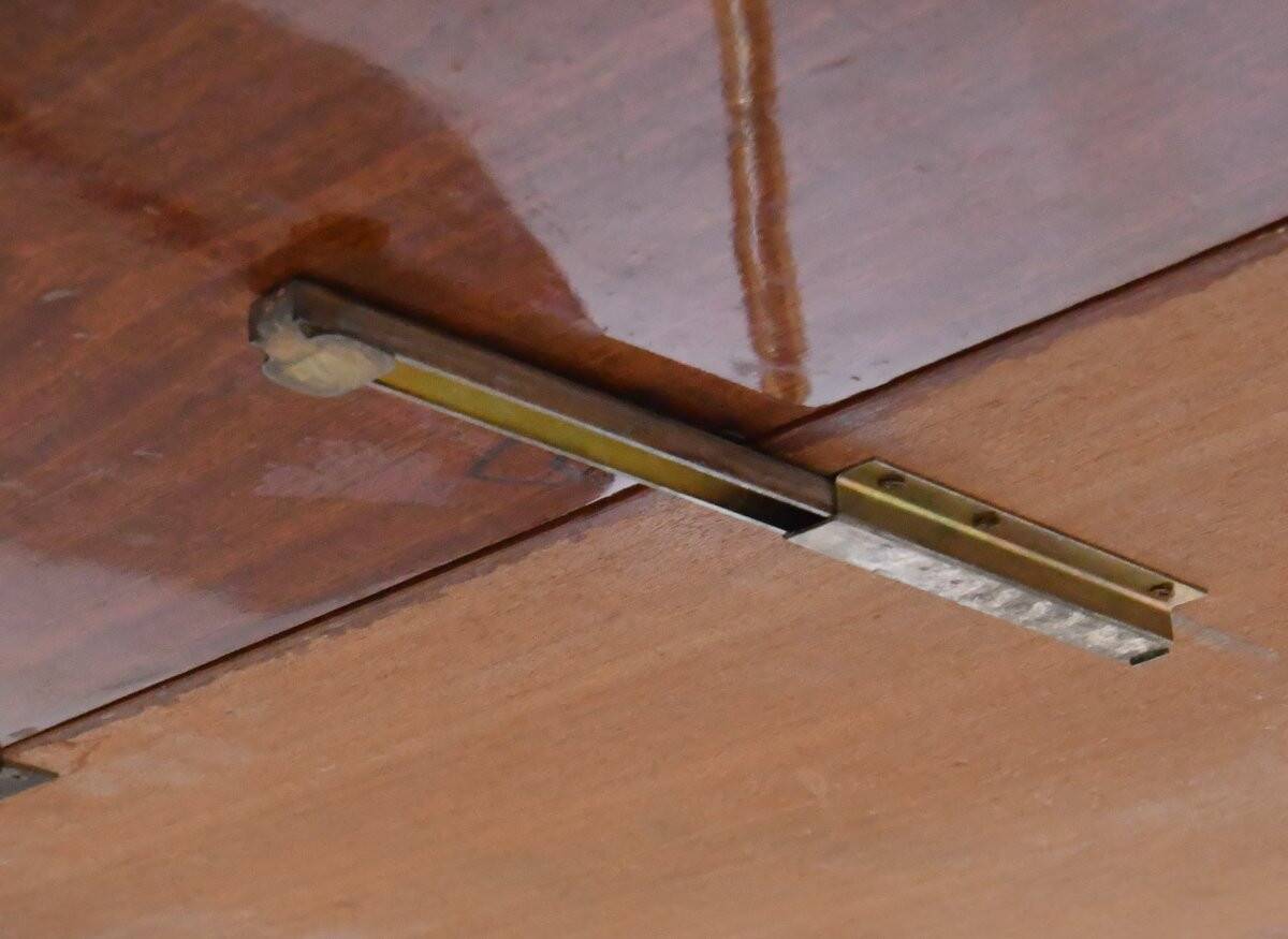 Serving table and rolling bar with drop leaves featuring floral marquetry decoration.