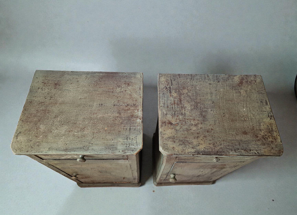 Pair of antique bedside tables with a green patina