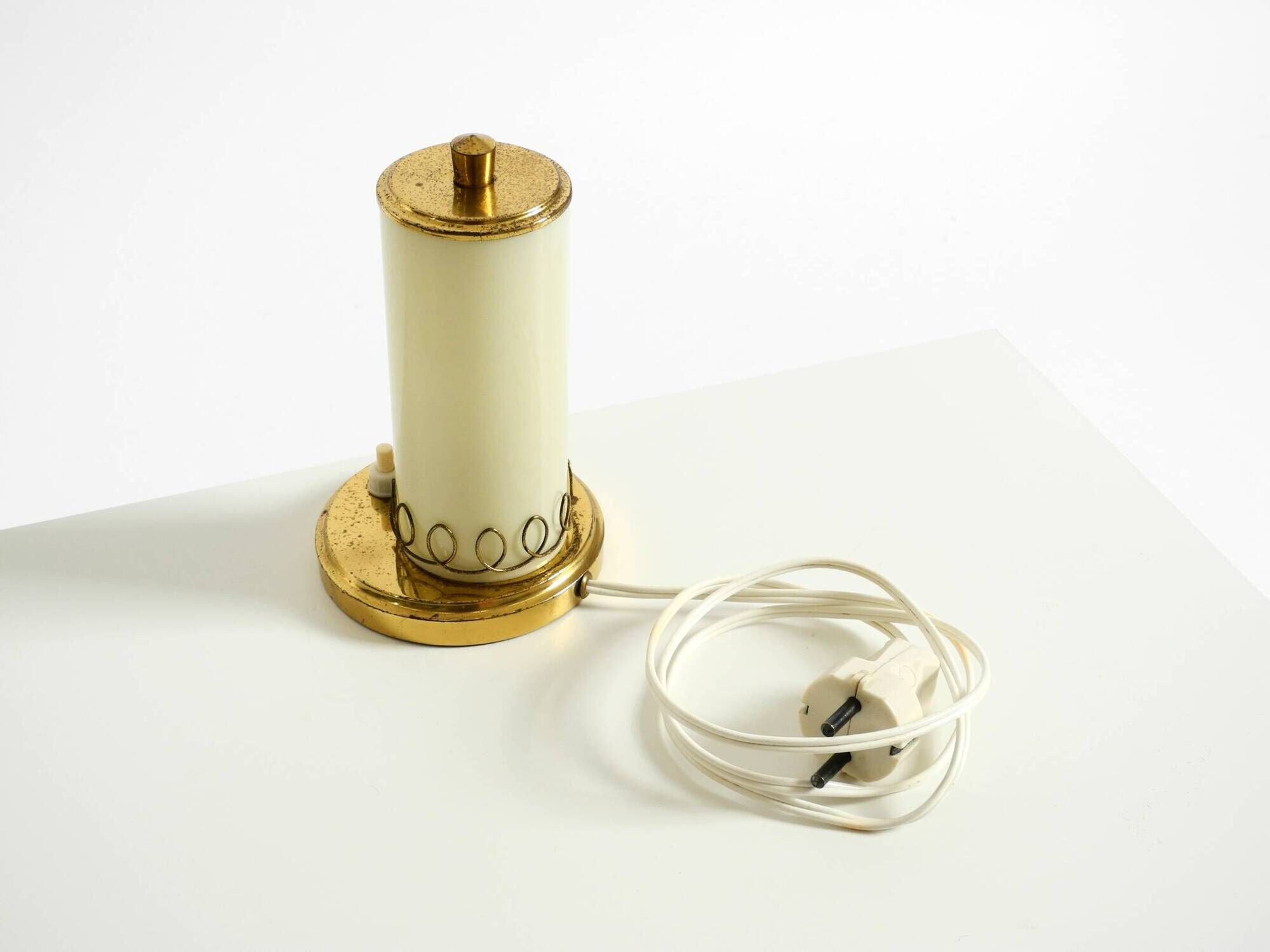 A beautiful, rare 1950s brass table lamp with one opal glass shade adorned