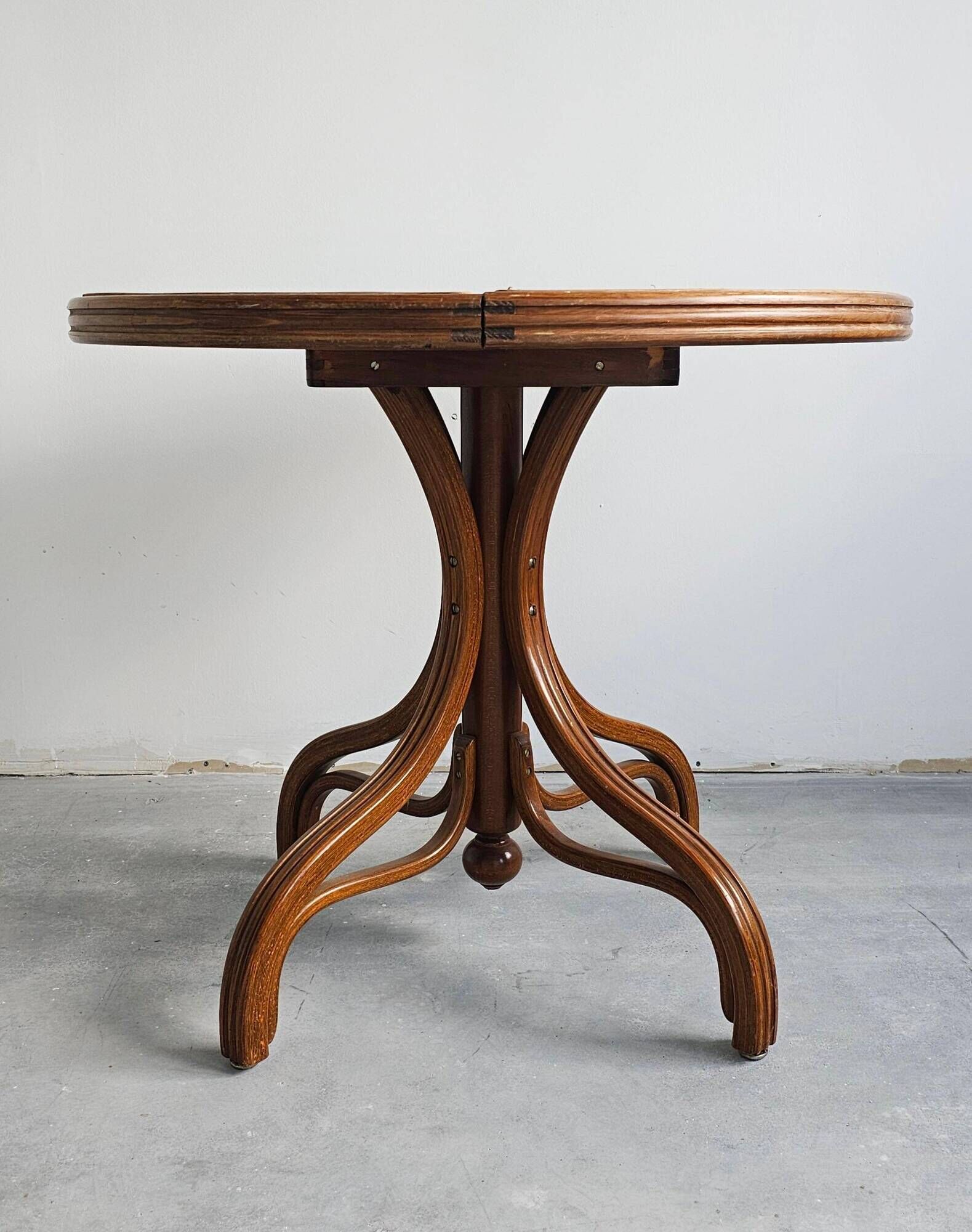Round dining table in curved wood with a rattan top by Mundus, 1960s.