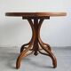 Round dining table in curved wood with a rattan top by Mundus, 1960s.