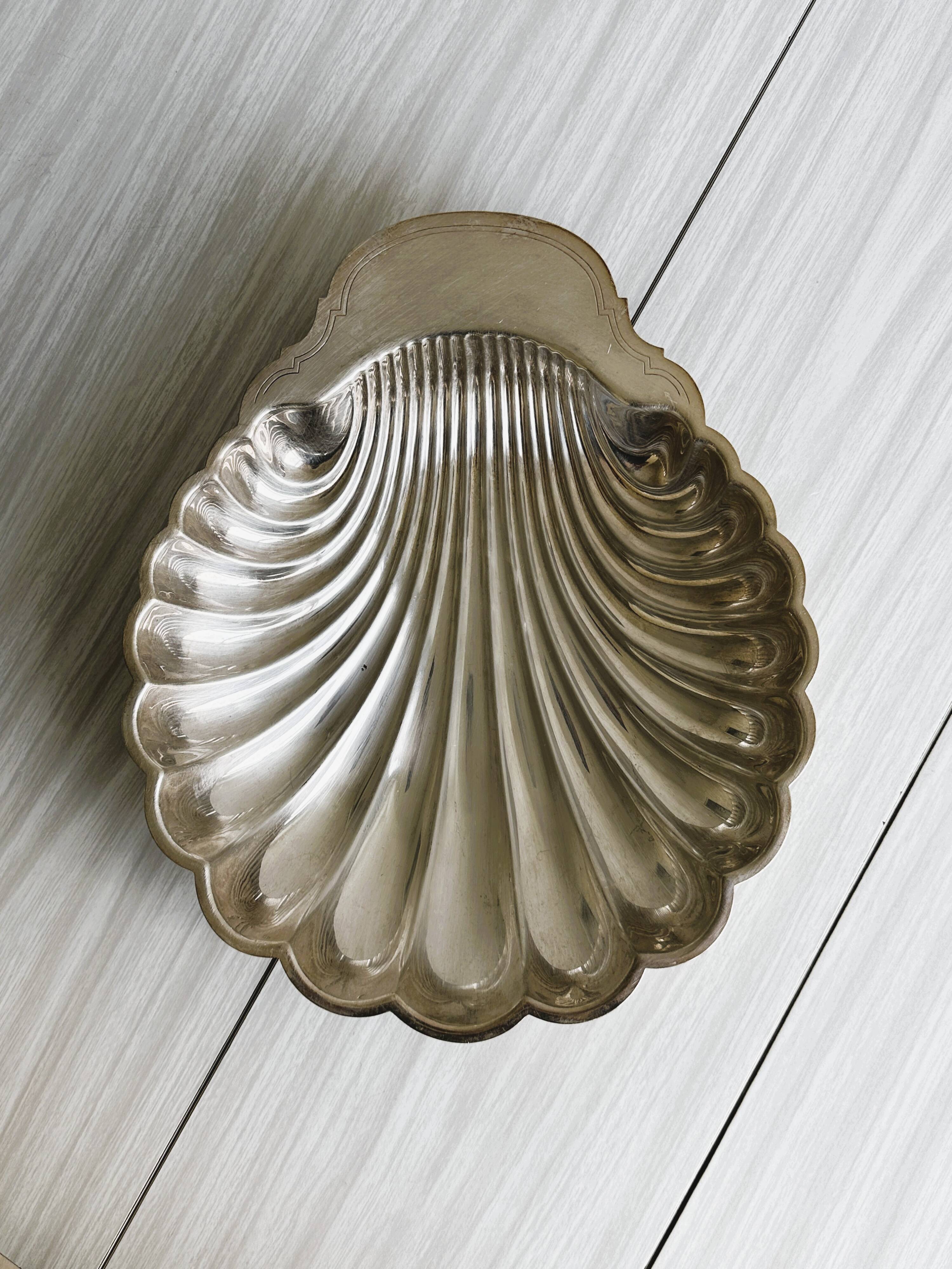 large silver-plated metal shell-shaped dish