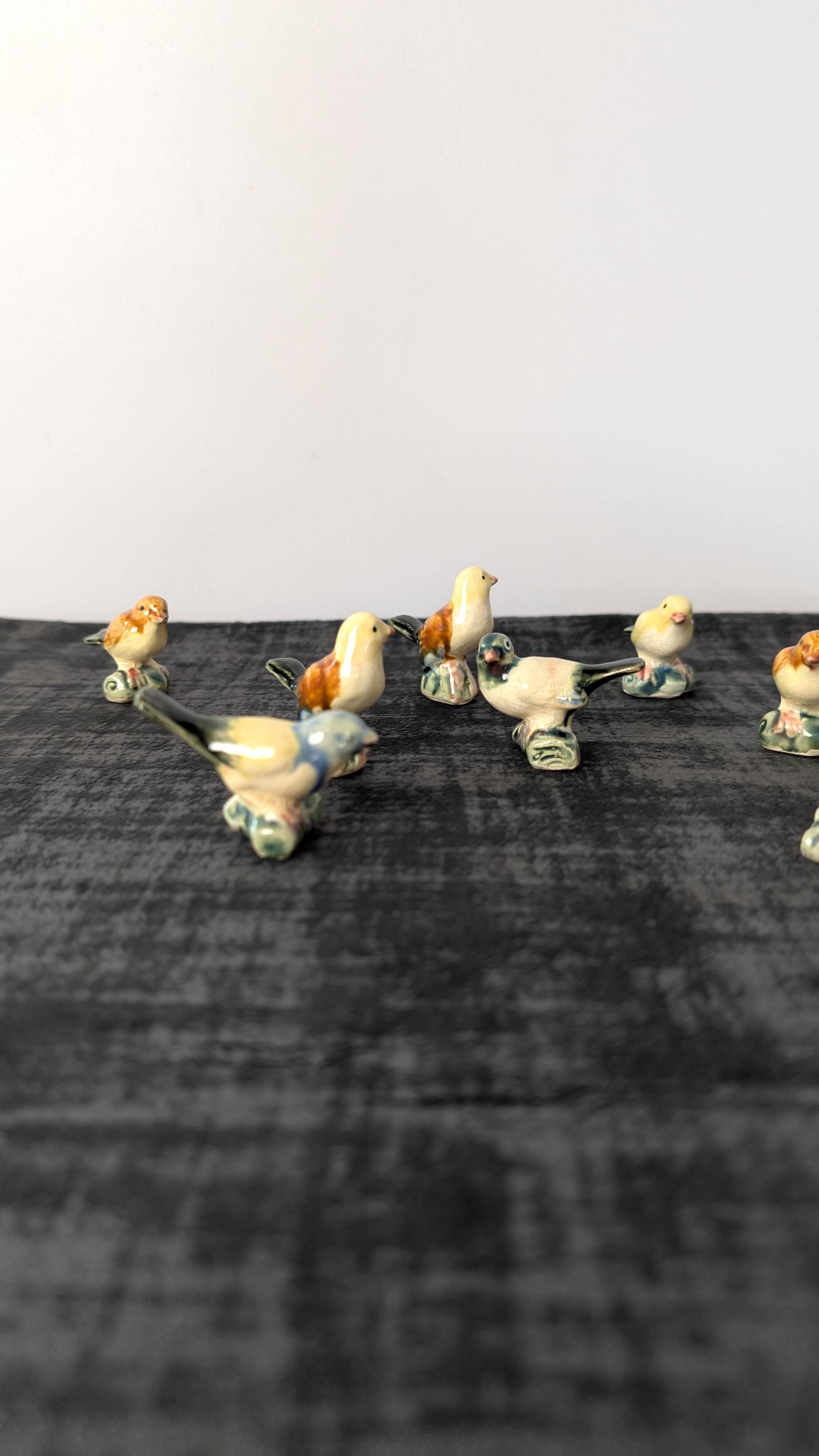 Set of 11 miniature birds in polychrome glazed ceramic.