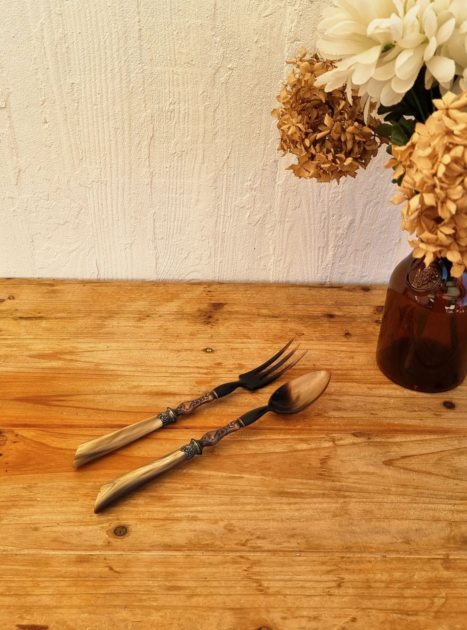 Vintage serving cutlery in horn and wrought metal