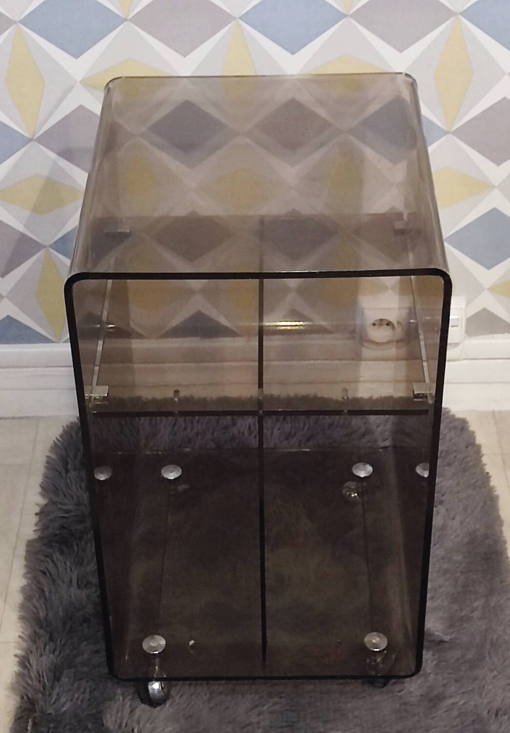 Michel Dumas smoked Plexiglas rolling table.