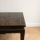 Chinese coffee table in black and gold wood.
