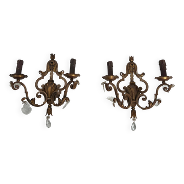 Pair of patinated wrought iron wall sconces with golden acanthus leaves and crystals.
