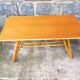Rattan coffee table with compass legs