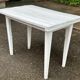 Vintage white wooden kitchen table with drawer from the 19th century.
