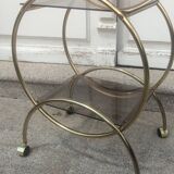 Service console with design / gilded metal wheels and smoked glass